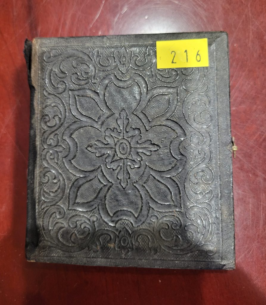 Here is a photo of the yellow "price tag" like sticker on the front of the ambrotype case.