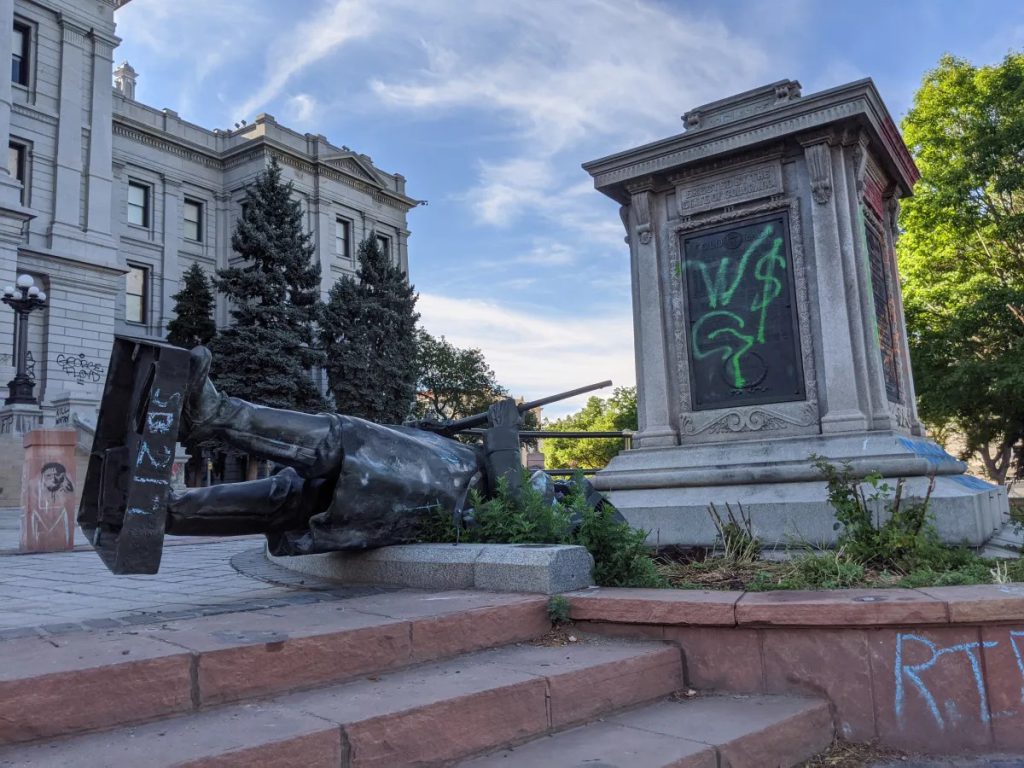 Image of the "On Guard" 1st Colorado Cavalry monument toppled after protests in Denver in 2020. The time capsule box was located under the pedestal that was recently removed.